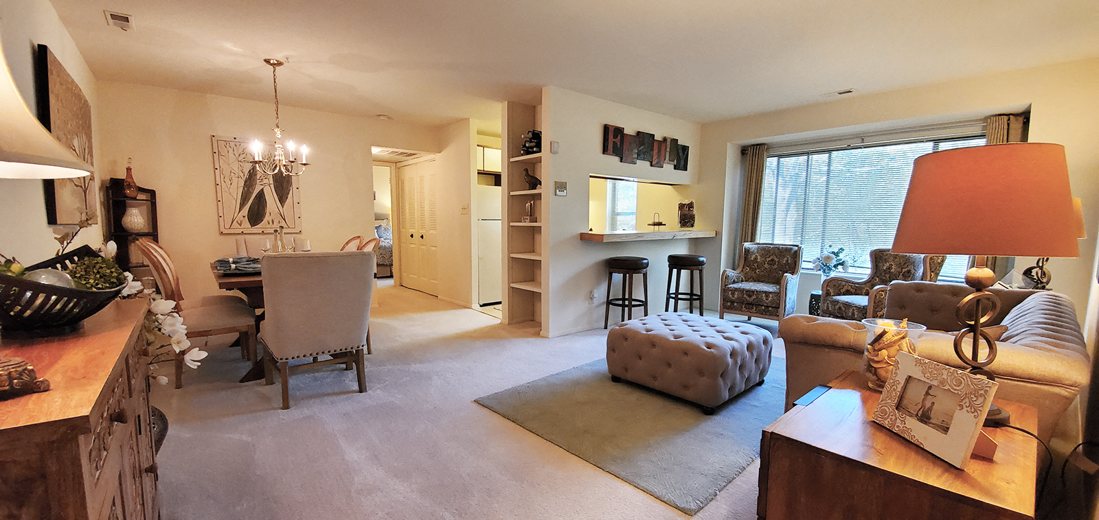 Living room area with balcony at The Bluffs at Clarys Forest Apartments, Columbia 21044